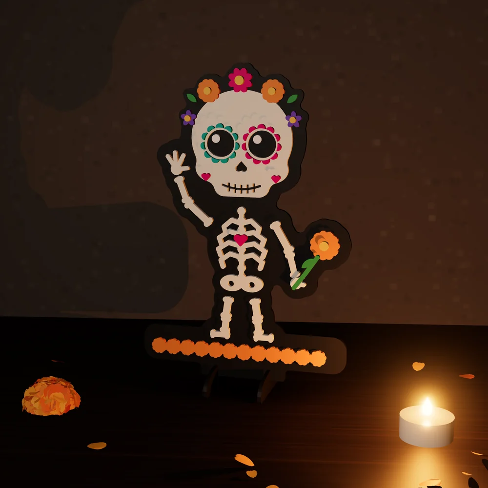 Calaverita de cuerpo completo: figura de MDF en 4 capas pintadas, parada en su base junto a una vela y pétalos de cempasúchil.