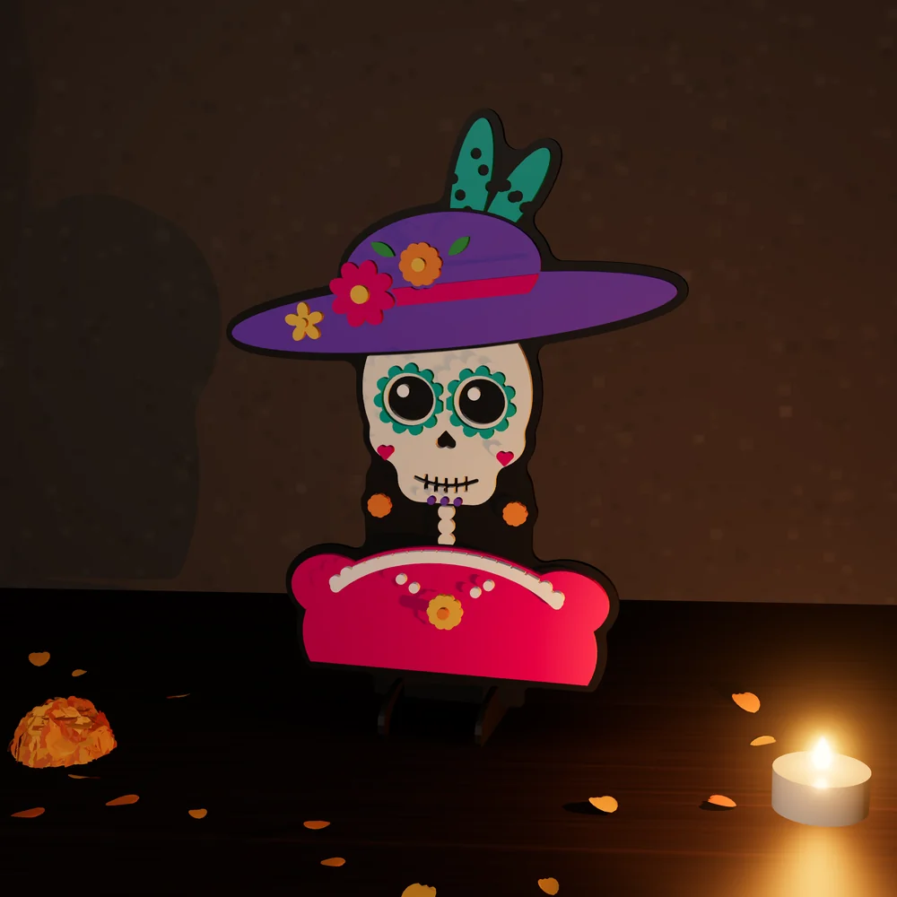 Catrina: figura de MDF en 4 capas pintadas, parada en su base junto a una vela y pétalos de cempasúchil.