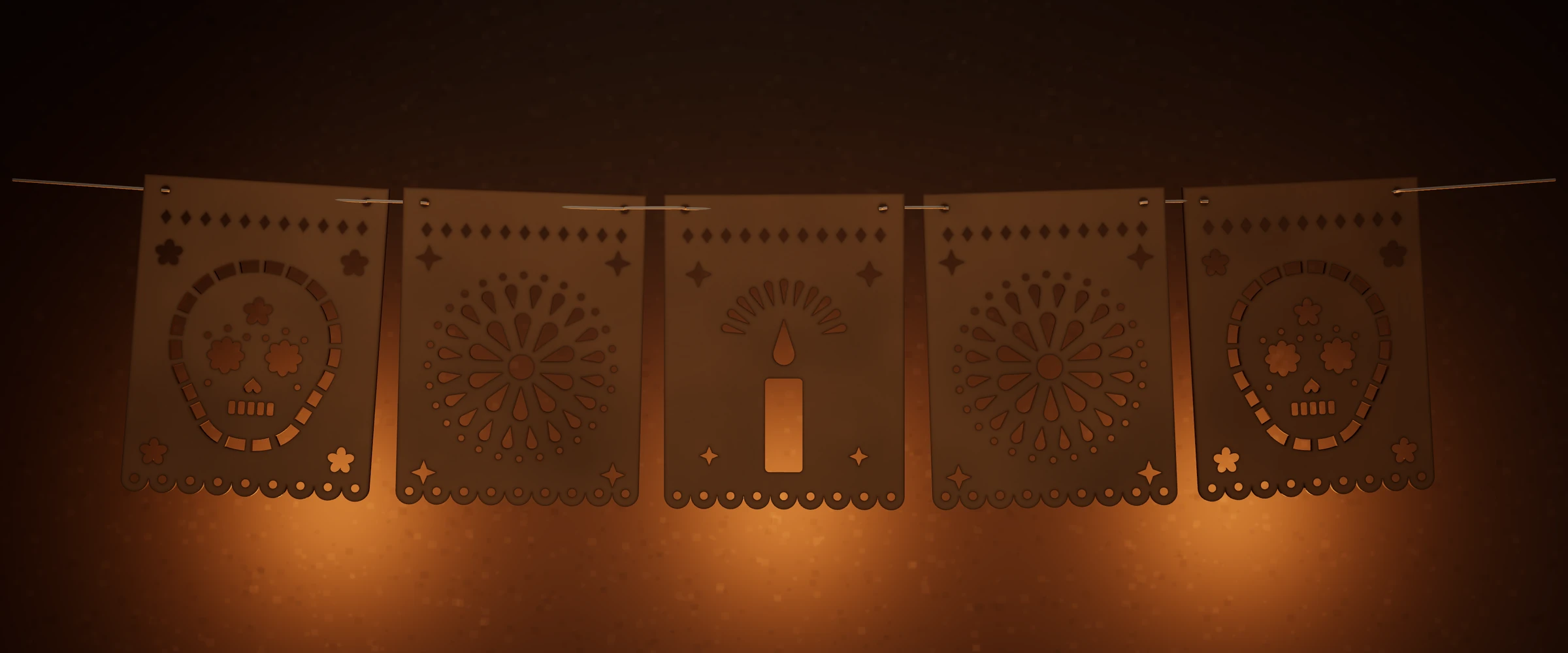 Tira de cinco banderas de papel picado cortadas en MDF —calaveras, cempasúchil y una vela— colgadas de un cordón, con luz de velas detrás.